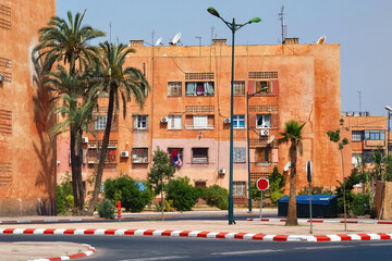 View of the red walls of the residential buildings in Marrakech on a sunny day. Morocco.