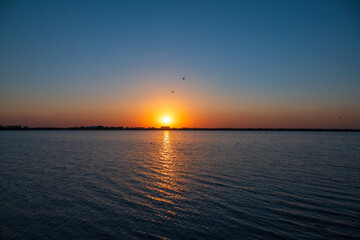The sun goes down over a lake