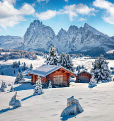 Christmas postcard. Bright winter view of Alpe di Siusi village with Plattkofel peak on background....