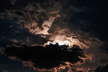 Thunderclouds at dusk at sunset. Shooting against the light. Selective focus.