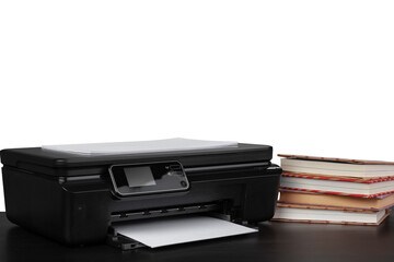 Printer and stack of books on black table against white background