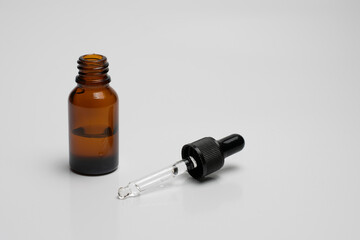 Essential serum oil in amber dropper bottle isolate on white background.