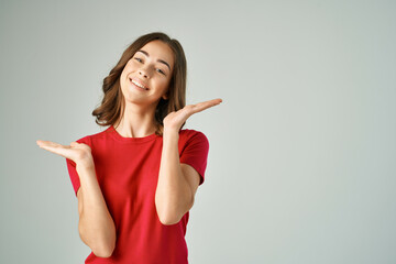 beautiful woman holding on to hair cosmetics light background