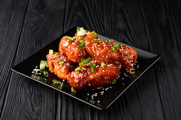 Korean fried chicken with black backdrop.