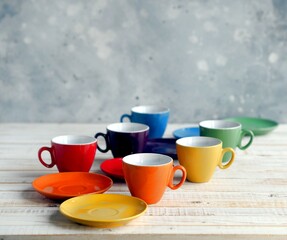 Bright multi colored tea cups cheer you up. Porcelain kitchen utensils.