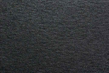 Texture of black shiny metallic paper