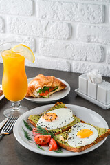 A set of products for a delicious European Breakfast Scrambled eggs, croissants and orange juice