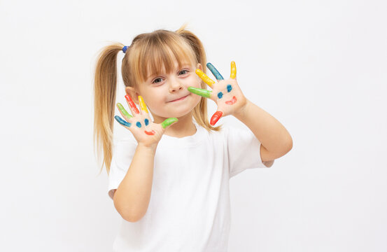 cheerful little girl with hands in paints isolated on white