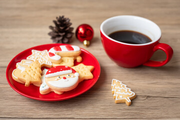 Merry Christmas with homemade cookies and coffee cup on wood table background. Xmas eve, party, holiday and happy New Year concept