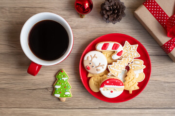 Merry Christmas with homemade cookies and coffee cup on wood table background. Xmas eve, party, holiday and happy New Year concept