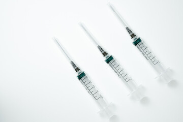 Medical syringe and needle on a light background