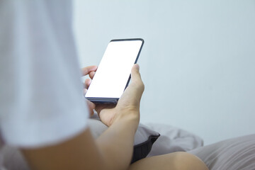 A man checks to browse online shopping on his smartphone  night at home at night.