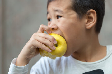 Child, little boy eating apple fruit