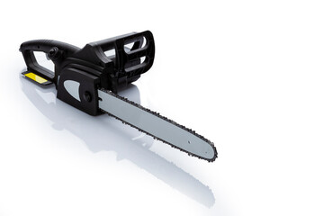 Professional tool electric chain saw isolated on white background. Electric hand tools.