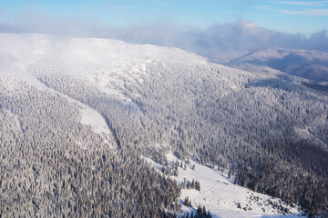 Fototapeta na wymiar Mountain valley covered with snow. Winter landscape.