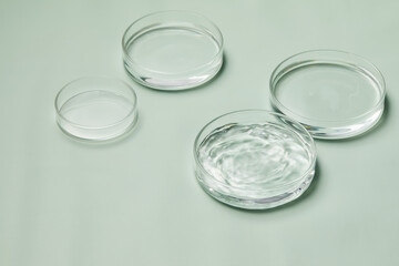 Petri dishes with water and ripple in green background