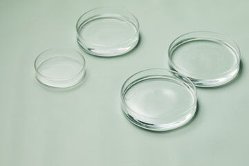 Petri dishes with water and ripple in green background