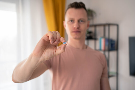 A young man takes a prep in a pill. HIV prevention concept. AIDS prevention concept.
