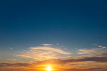 Amazing dawn against a clear sky with a bright sun in the clouds