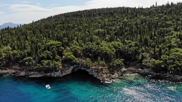 Cypress And Olive Tree Forest On Rocky Outcrop At Foki Beach In Ionian Island, Kefalonia, Greece. aerial sideways