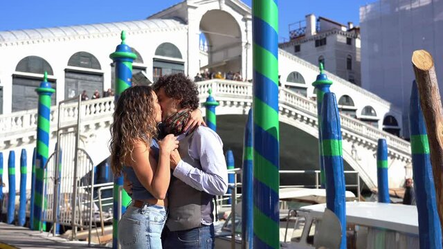 40-year-old man makes a marriage wedding proposal to his girlfriend by giving an engagement ring and kisses in Venice, the city of love, near the Rialto bridge - request to get married