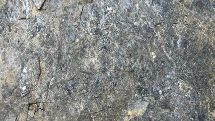 An old stone blur with beautiful streaks, colored in brown, yellow, blue, white and black as wallpaper themes.