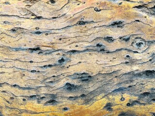 An old stone blur with beautiful streaks, colored in brown, yellow, blue, white and black as...
