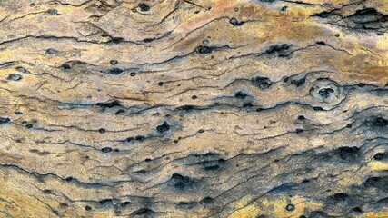 An old stone blur with beautiful streaks, colored in brown, yellow, blue, white and black as...