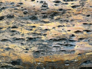 An old stone blur with beautiful streaks, colored in brown, yellow, blue, white and black as wallpaper themes.