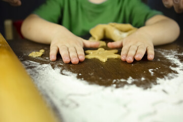 The child made his own snowflake cookies. Homeschooling concept. Delicious and beautiful food prepared by a child. Children's pens.