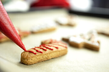 A closeup of a cookie. Christmas cookies. Decorate the cookies with red icing. Close-up.