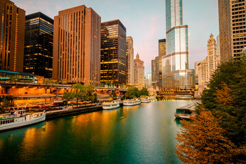 Early morning view of moored tour boats at the main stem of the Chicago River with skyscrapers in...