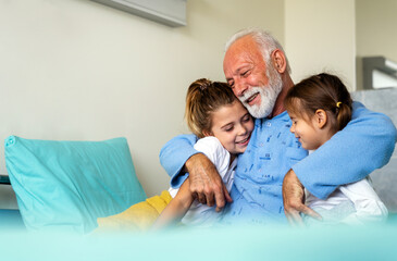 Family visiting senior male patient in hospital bed. Healthcare, support, family concept
