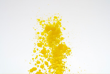 Oil drops isolated. Golden liquid drops of oil in water on a white background. Food or cosmetics component.