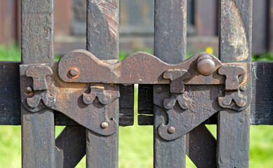 Closeup old rusty metal fence, fragment of the lock