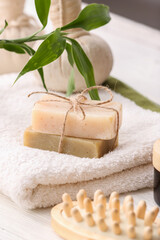 Spa set with soaps on light background