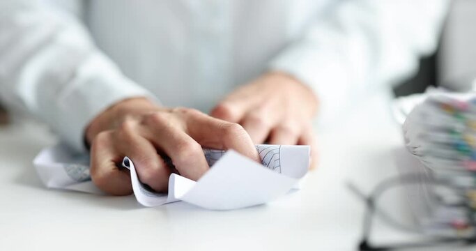 Female hand crumpling paper document with numbers in office closeup 4k movie slow motion