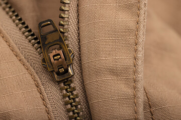 Close up of metal zipper and clothing brown pattern background