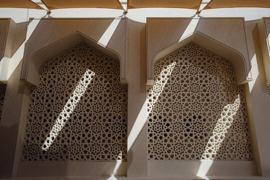 Travel destinations and heritage village of old Dubai. Arab Street in the old part of Dubai. Al Seef Clay Houses. Deira, BurDubai, Bright sunny afternoon on stone street in traditional oriental city.