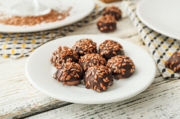Plate with tasty flax seed candies on table