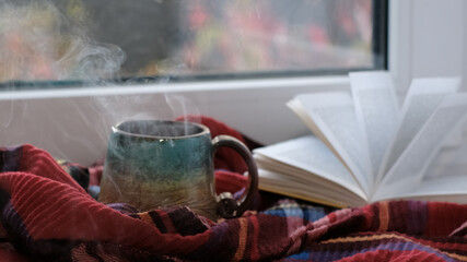 Close up. Steaming coffee cup on a rainy day window background. cozy atmosphere, in cold weather. Rainy Day Mood. Close up. Steaming coffee cup on a rainy day window background. cozy atmosphere, in