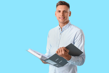 Young man with folder on color background
