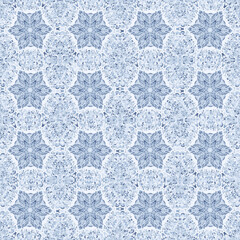 Snowflakes lie on a frosty background. Light pattern. Blue shades.