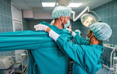 Team of surgeons in the operating room preparing for surgery