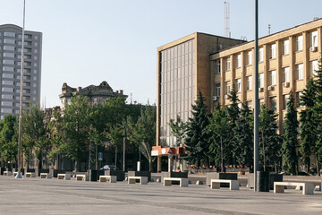 View of modern square with green trees and building