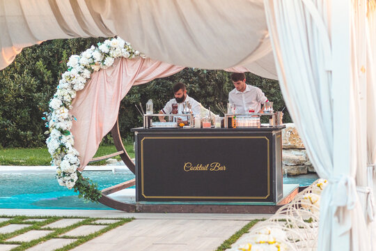 Bartenders Mixing Drinks And Cocktails Outdoors In A Resort