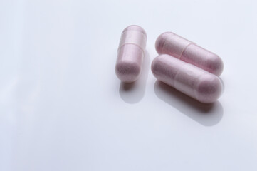 close up of medical capsules on white background