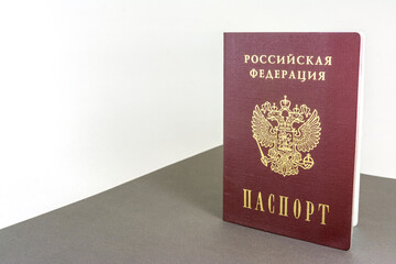 The Russian passport stands upright on the table.
