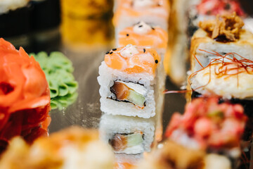Assorted sushi nigiri and maki big set on mirrow plate.Sushi and sushi roll set, sushi rolls served...