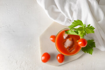 Board with glass of bloody mary on light background © Pixel-Shot